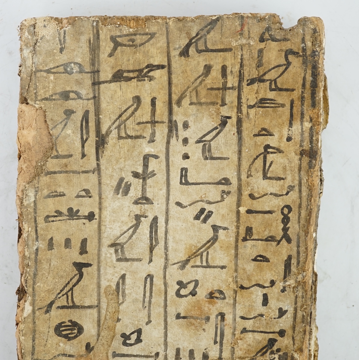 An Ancient Egyptian painted gesso, linen and wood fragment from a coffin or canopic chest, probably late Kingdom